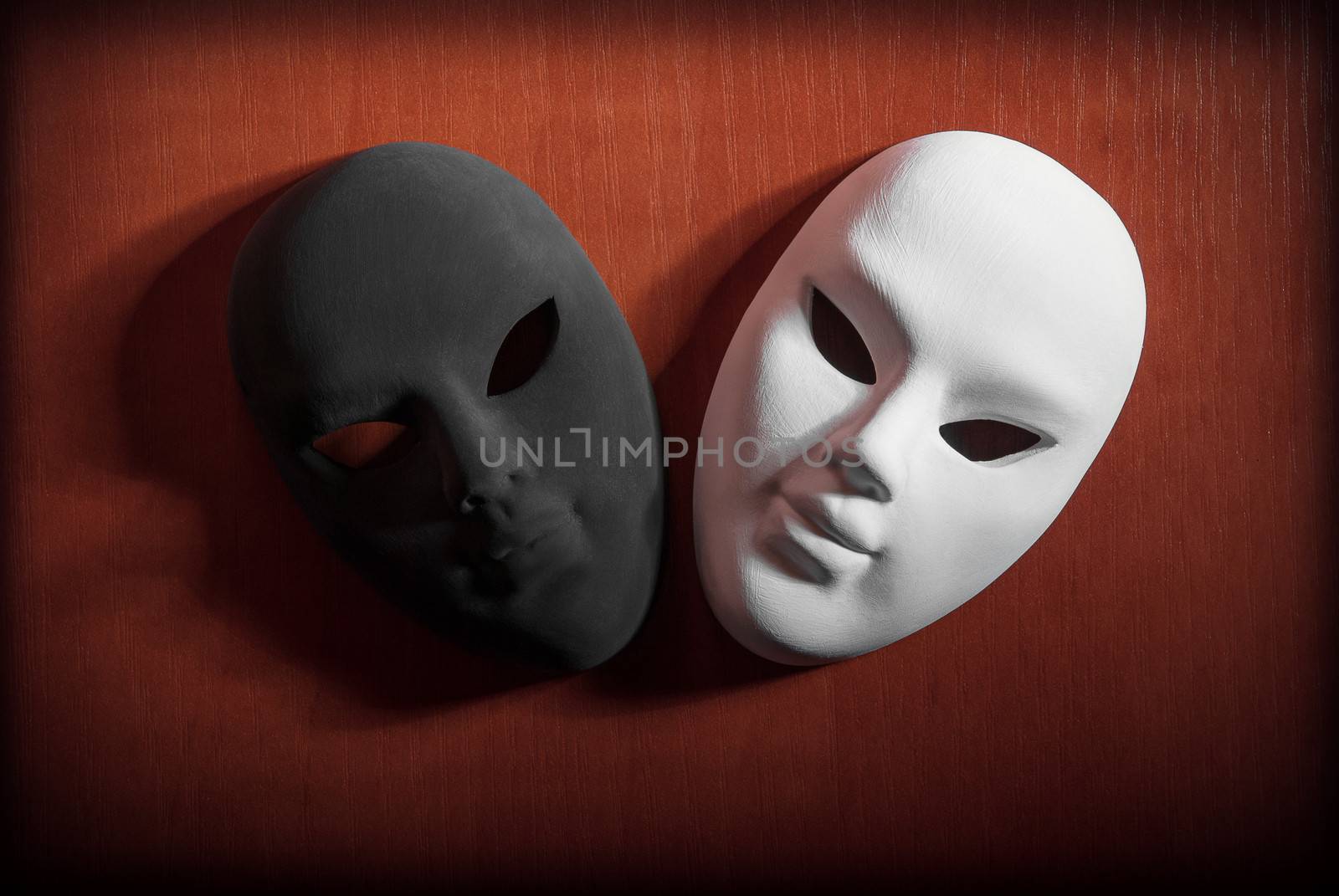 Black and white carnival mask on a wooden background.