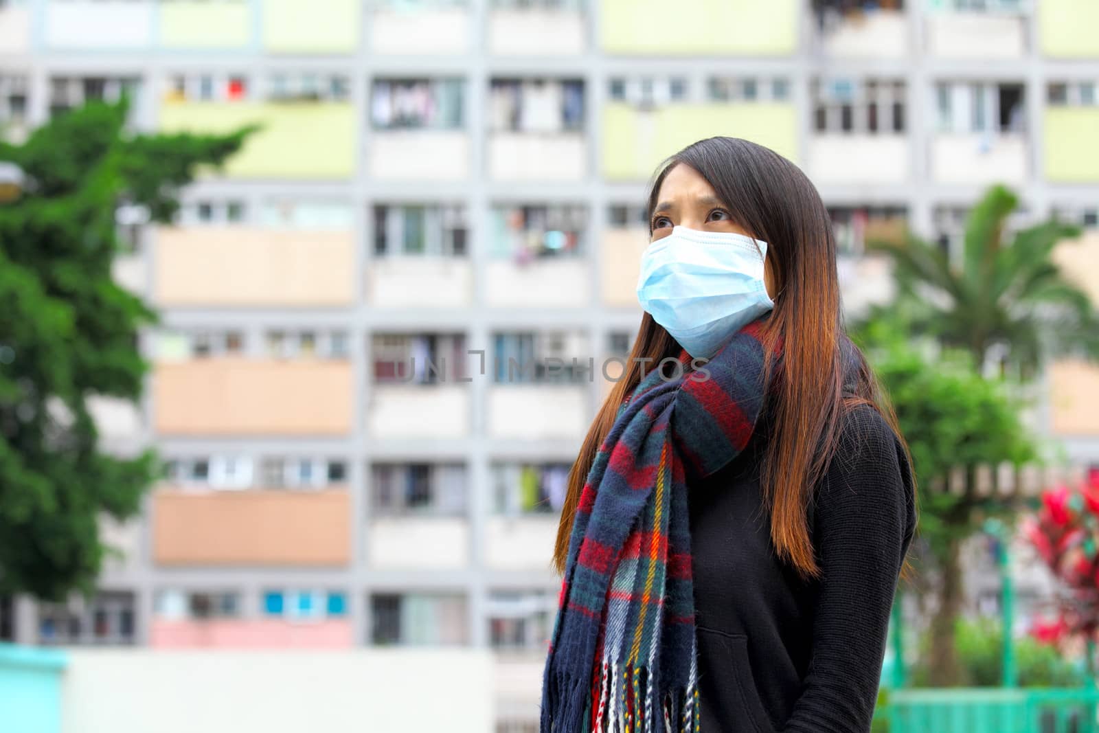 Woman wearing medical face mask in crowded city