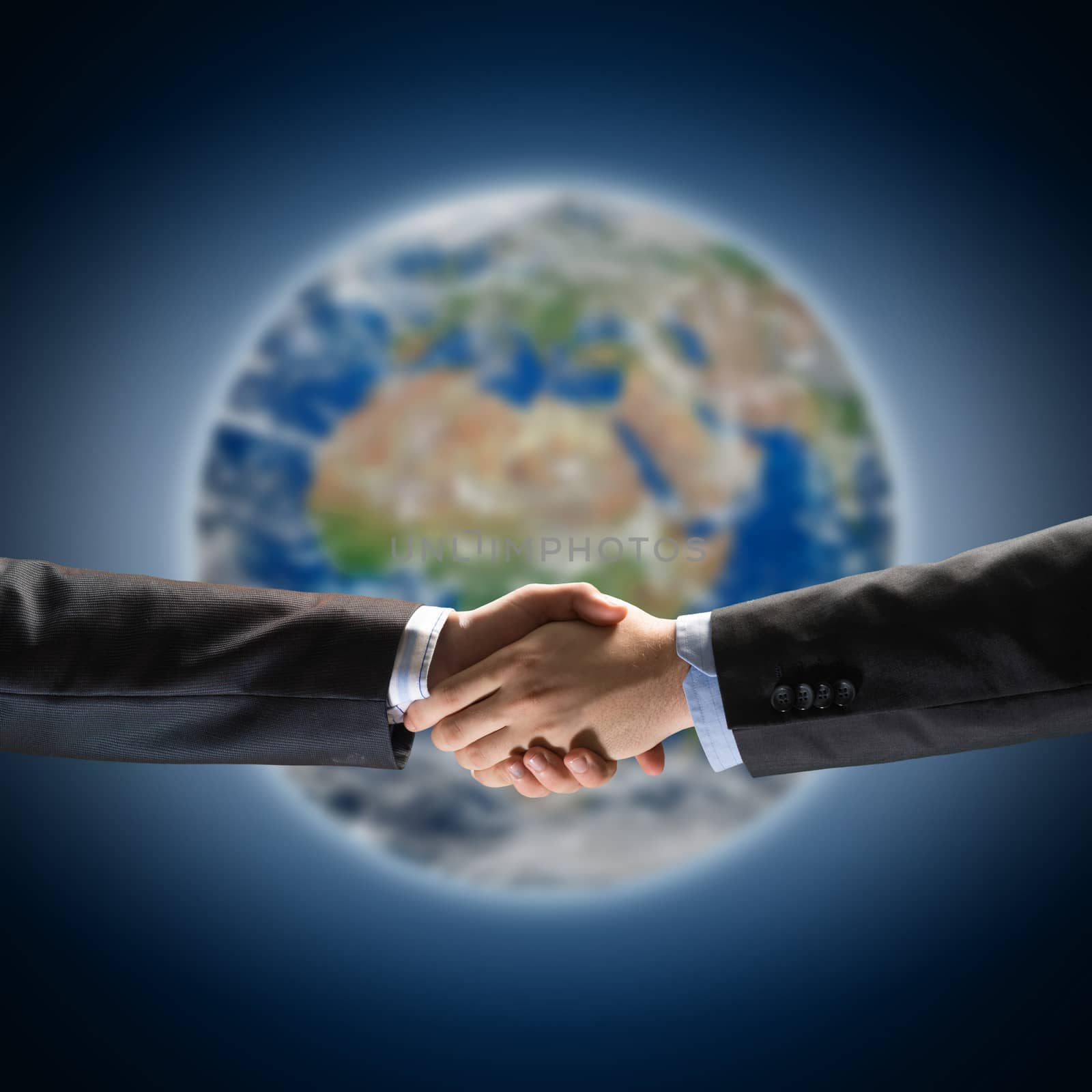 handshake of two businessmen on the background of the planet earth. Elements of this image are furnished by NASA