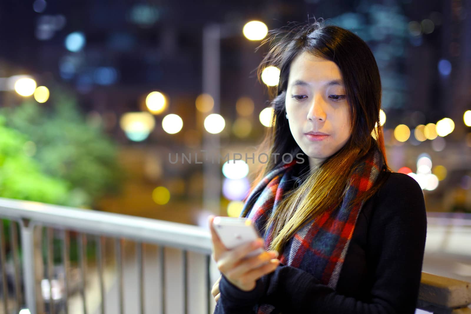 Asian woman using mobile at night