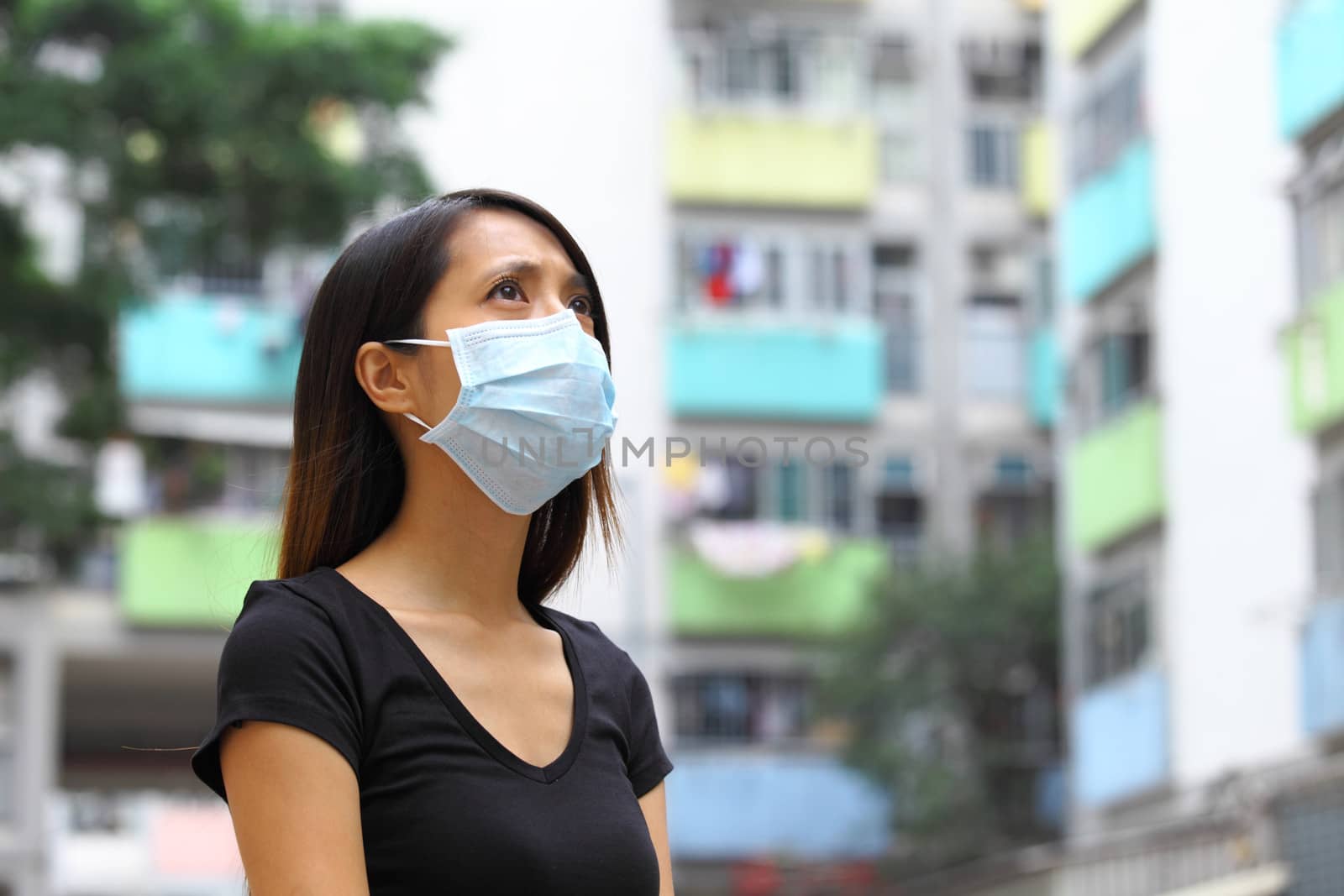 Woman wearing medical face mask in crowded city