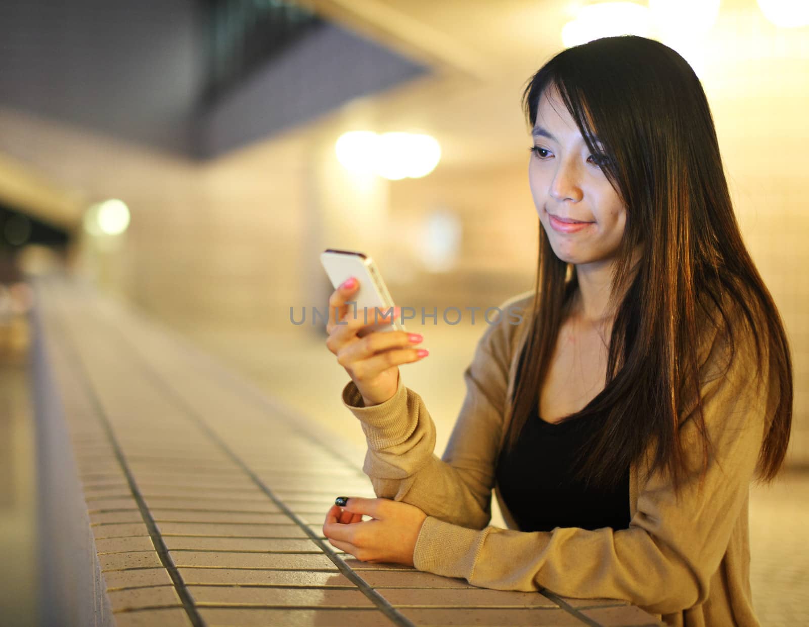 Asian woman using smartphone at night
