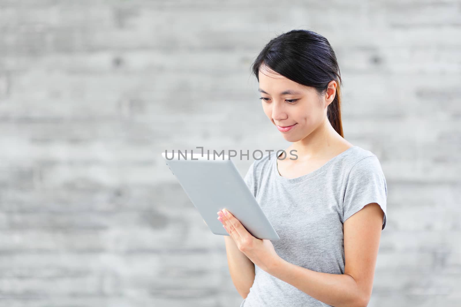 young asian woman using tablet computer