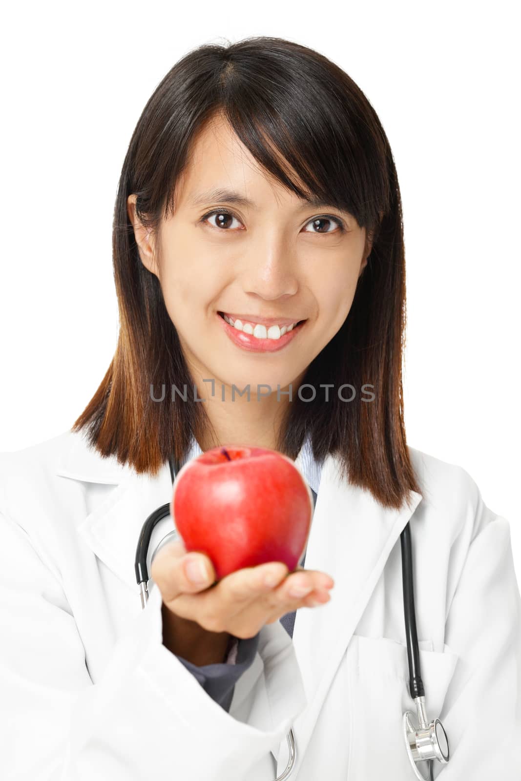 Asian female doctor holding red apple by leungchopan