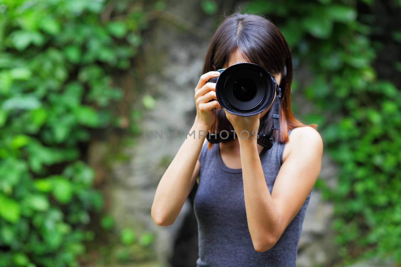 Asian woman taking photo by leungchopan