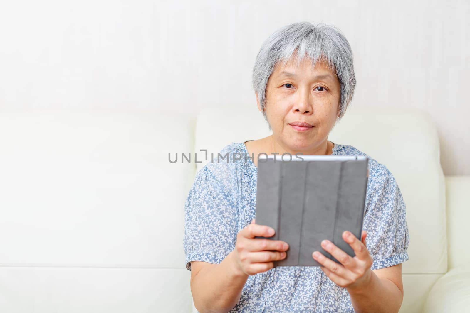 Asian old woman with digital tablet