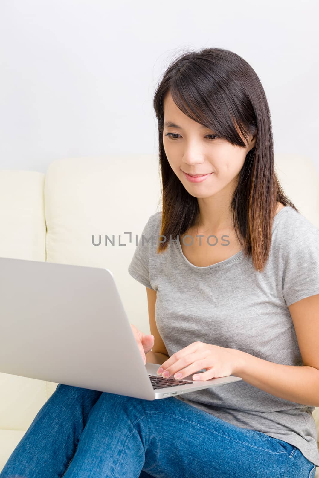 Asian woman using laptop by leungchopan