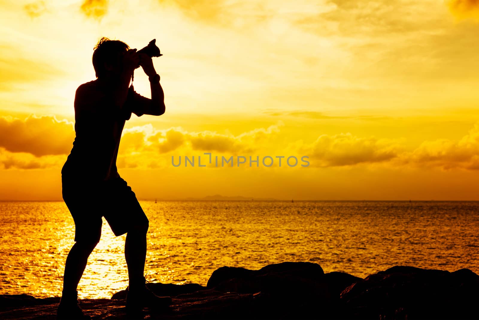 Silhouette of photographer at sunset