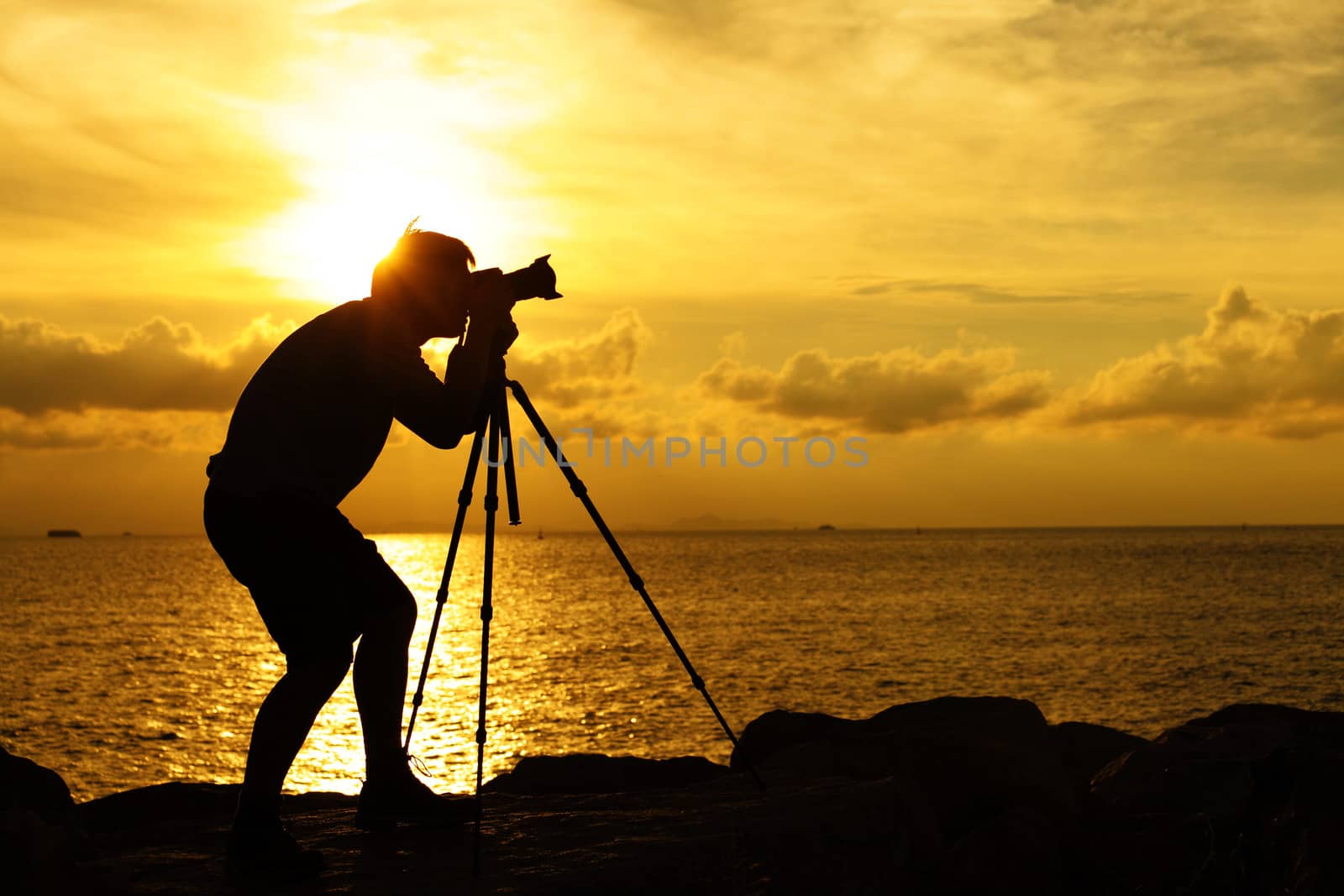 Silhouette photographer at sunset