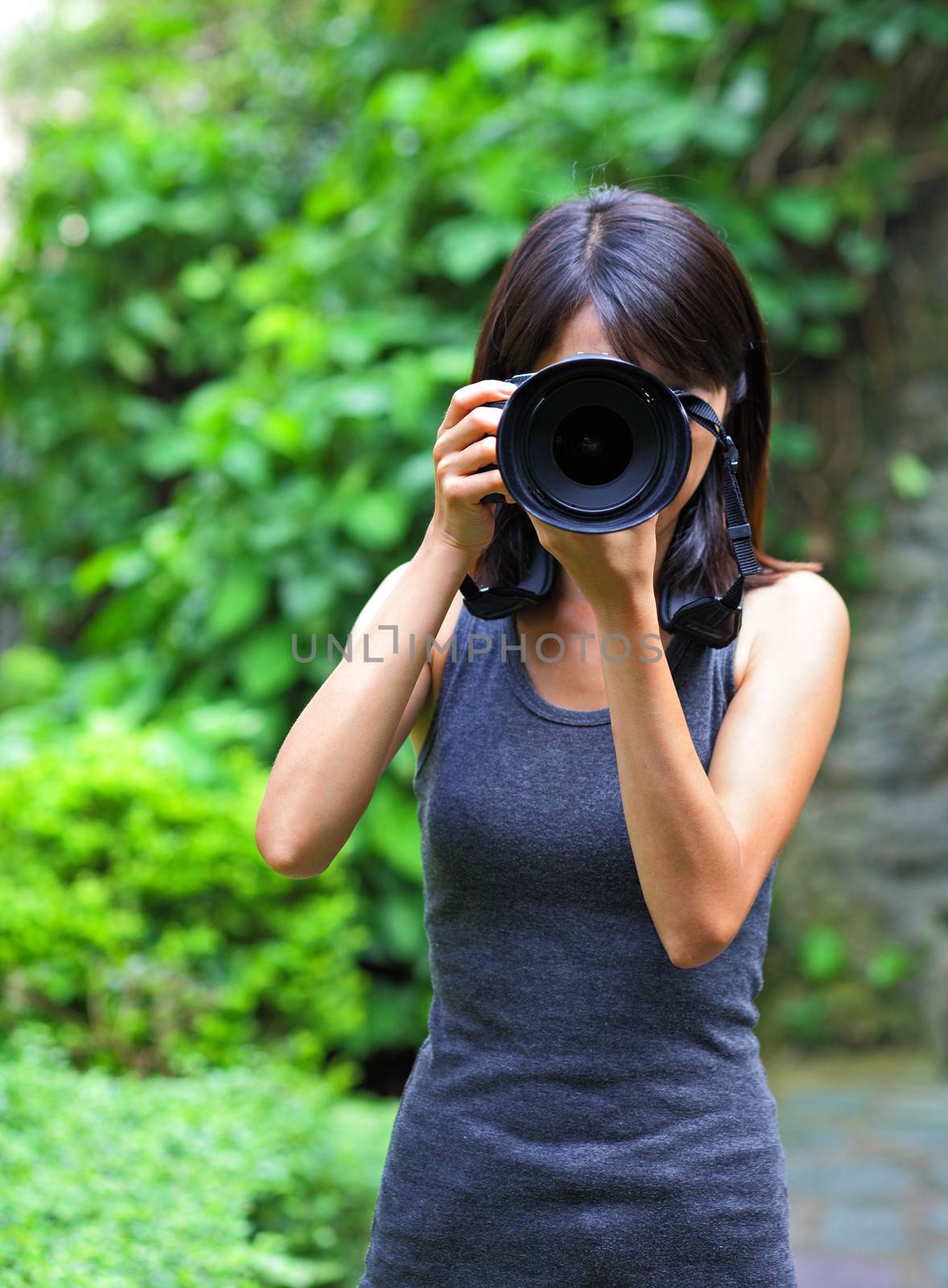 Asian woman taking photo by leungchopan