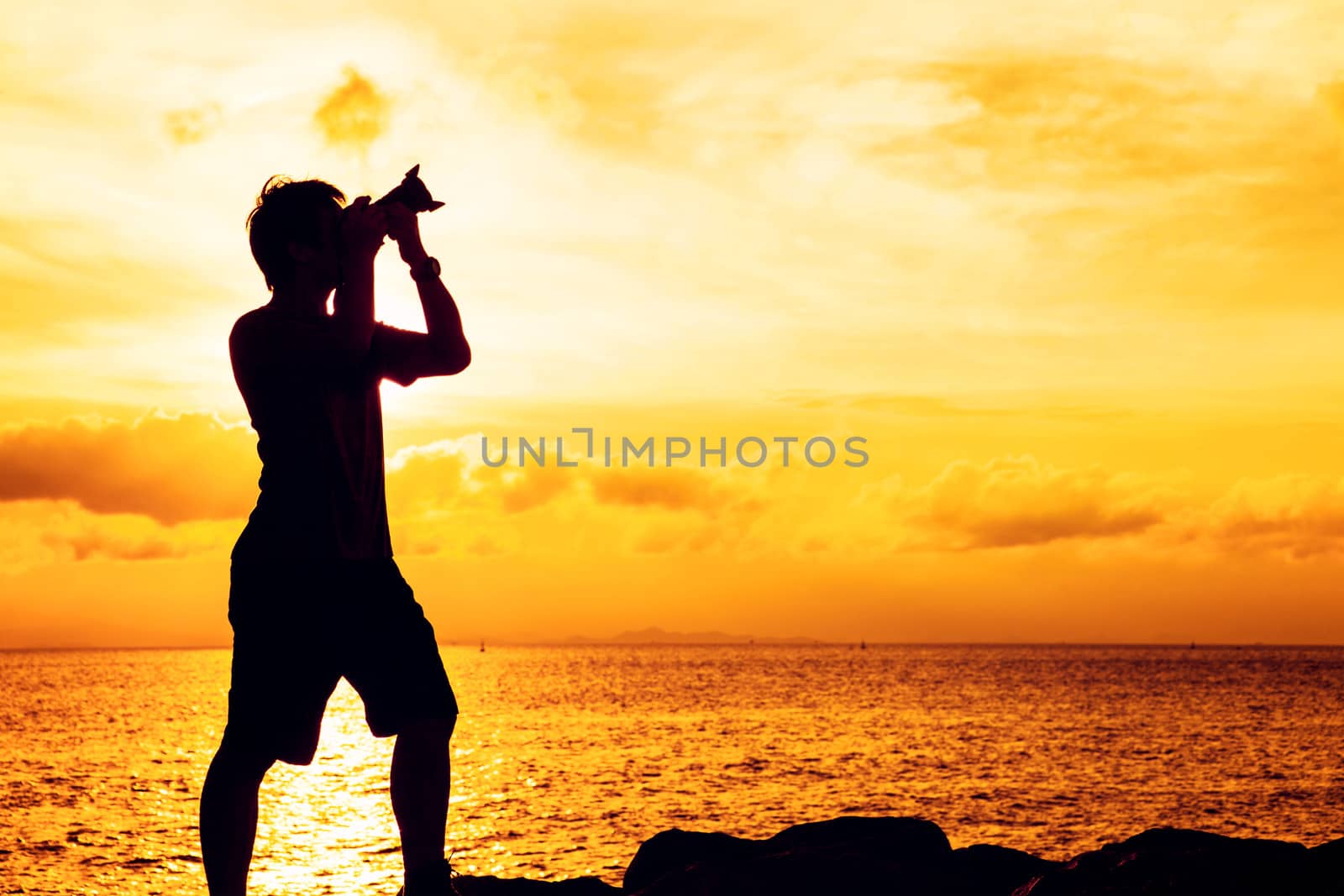 Silhouette of photographer at sunset