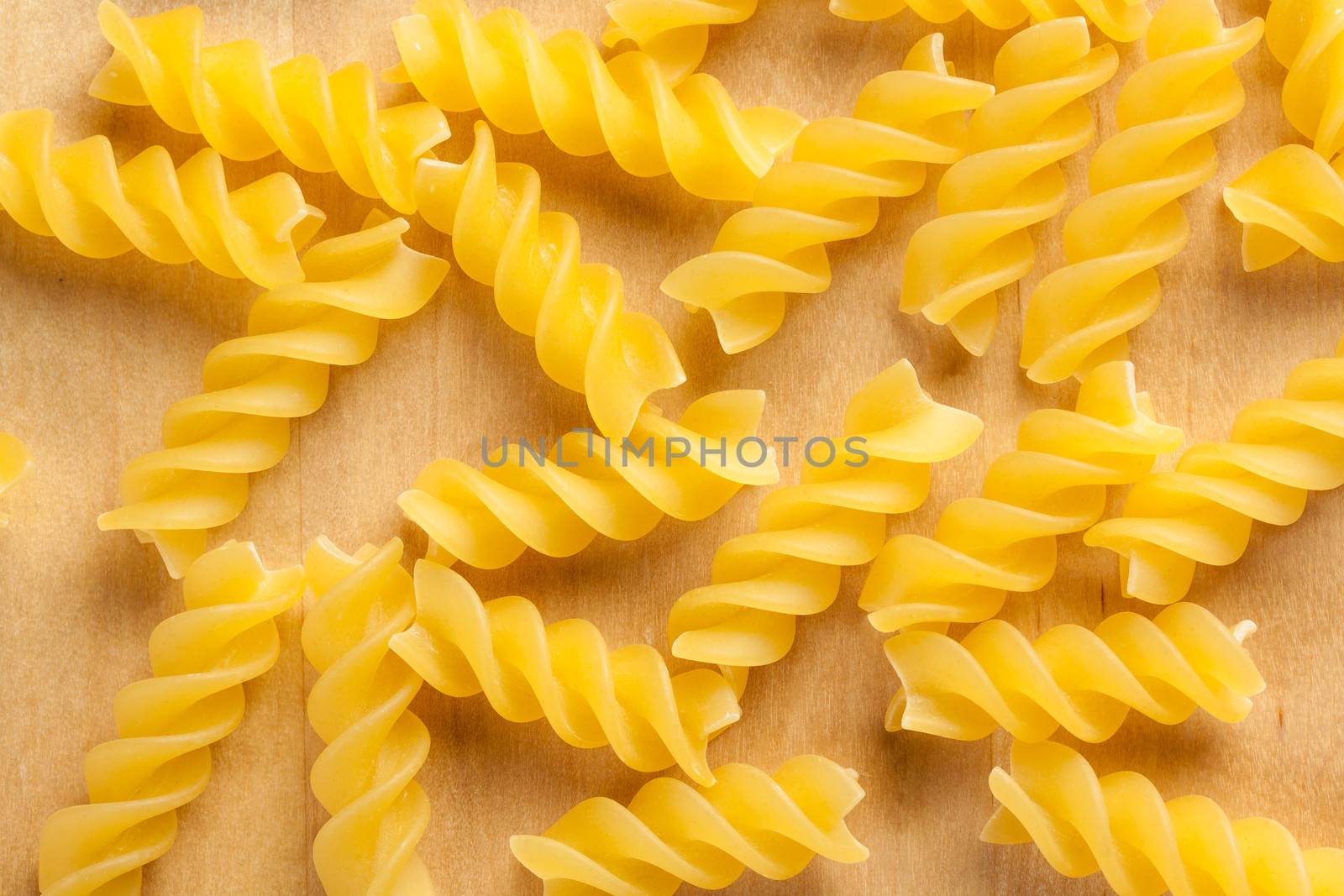 some fusilli italian pasta on wood