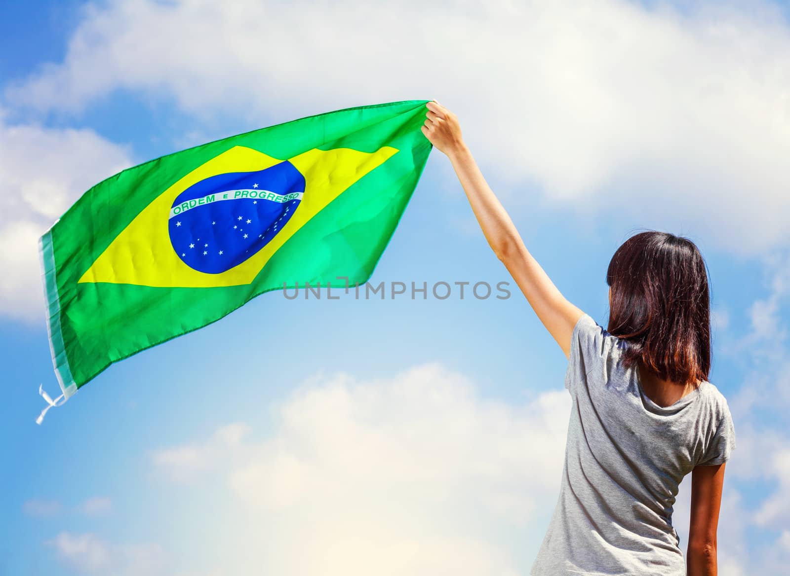 Woman holding a brazil flag by leungchopan