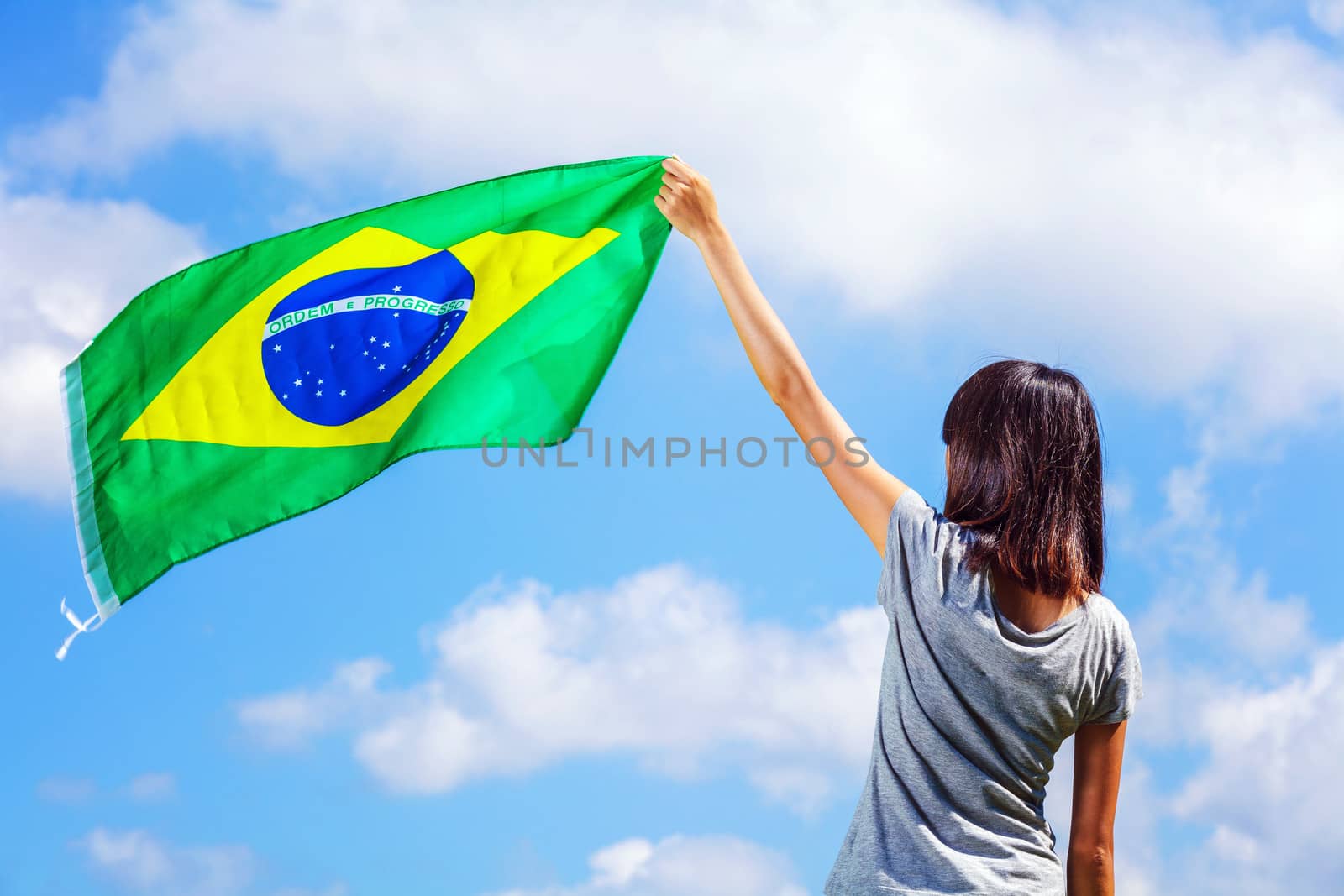 Woman holding a brazil flag by leungchopan