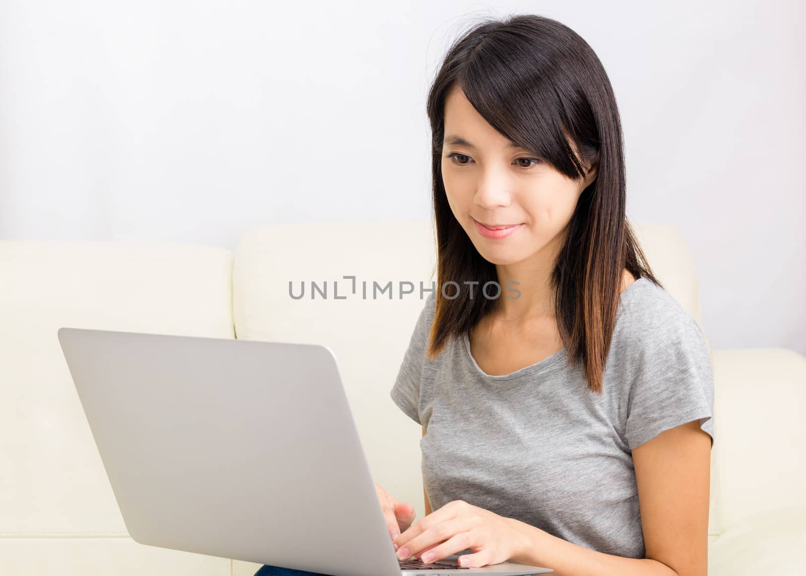 Asian woman using laptop by leungchopan
