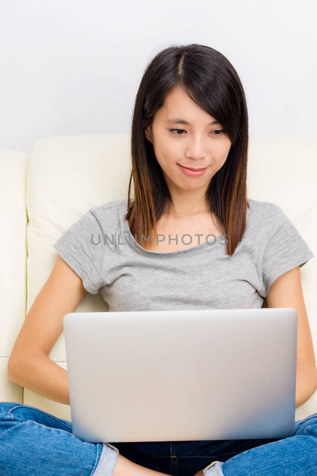 Asian woman using laptop by leungchopan