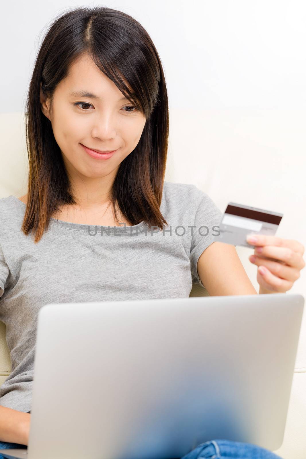 Asian woman using laptop for online shopping by leungchopan
