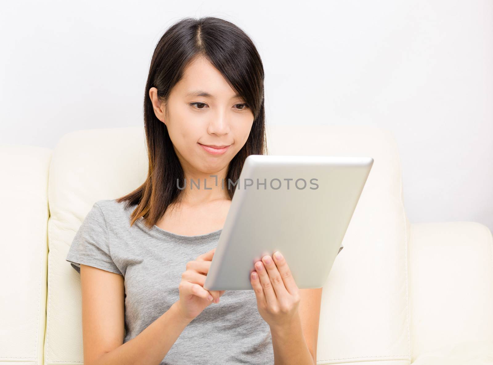 Asian woman using digital tablet by leungchopan