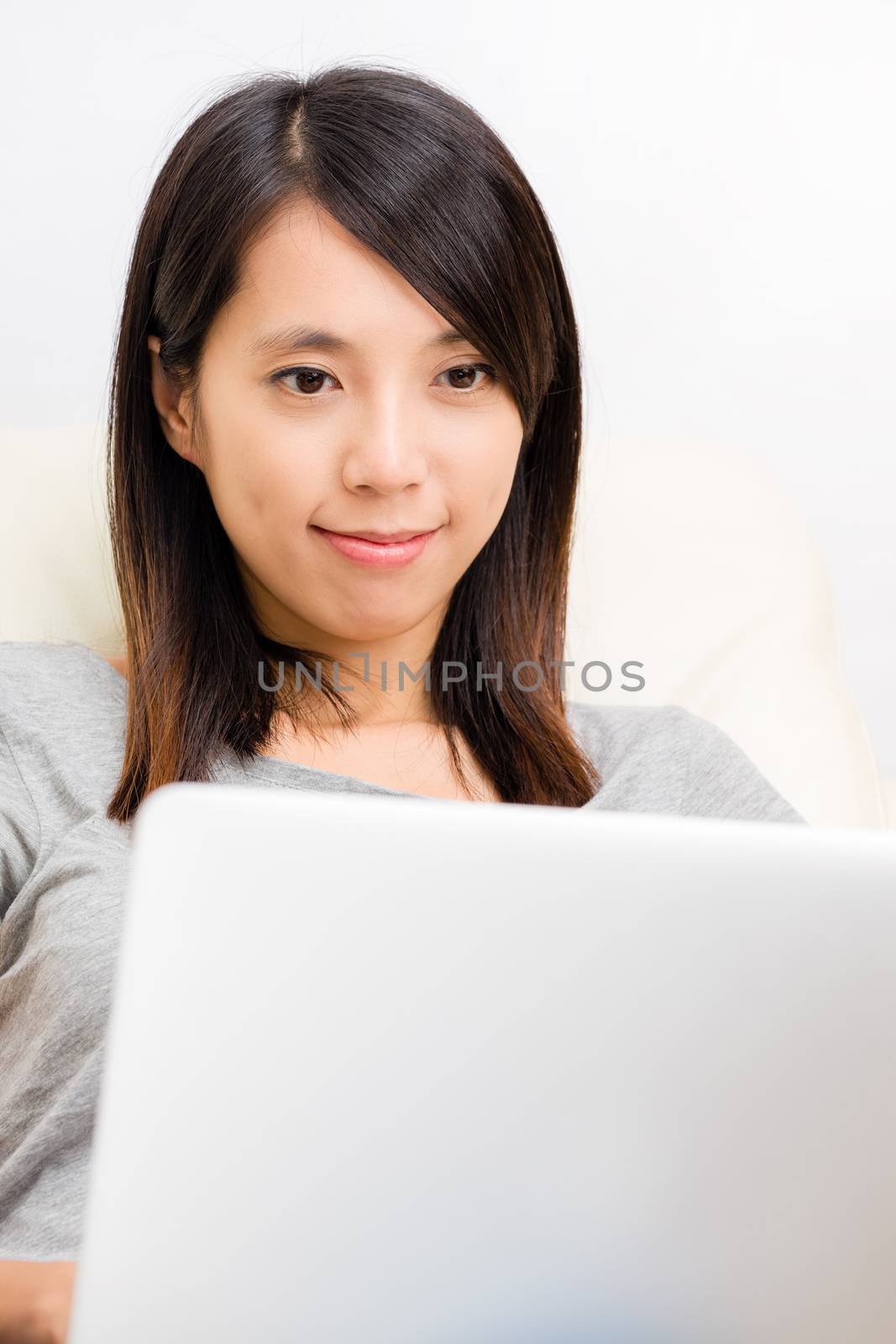 Asian woman lookting at laptop