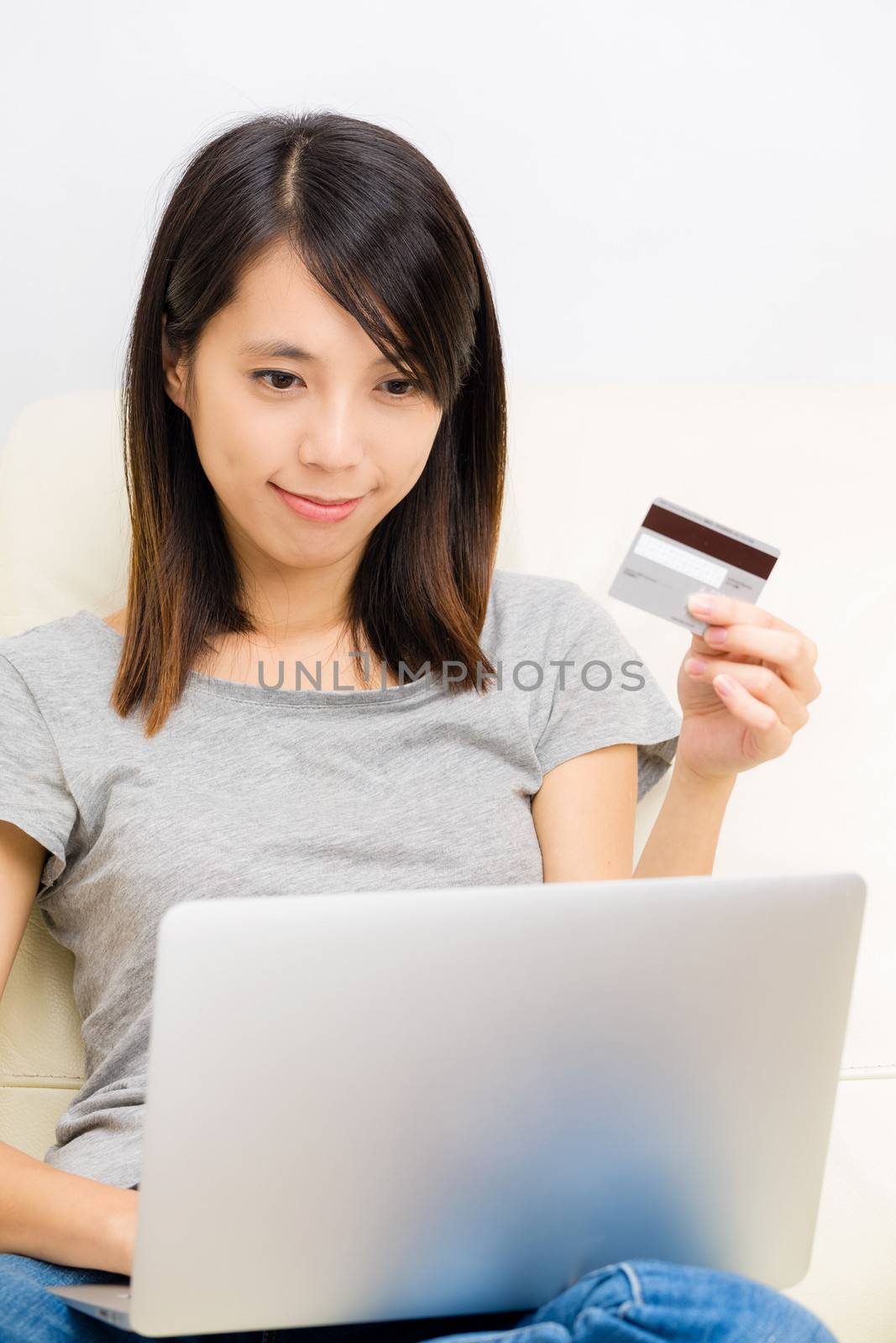 Asian woman using laptop for online shopping by leungchopan