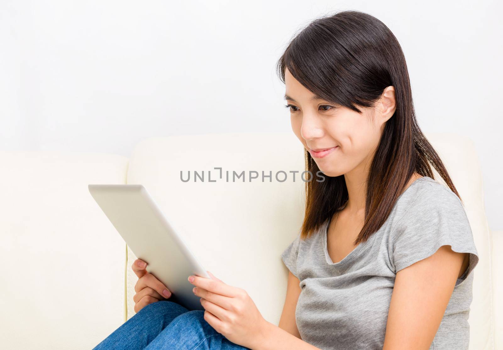 Asian woman looking at digital tablet