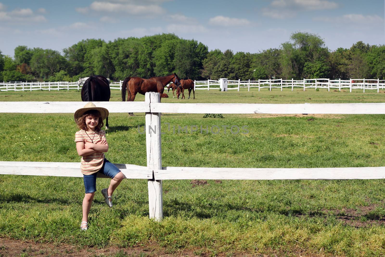 beautiful little girl with cowboy hat on ranch by goce