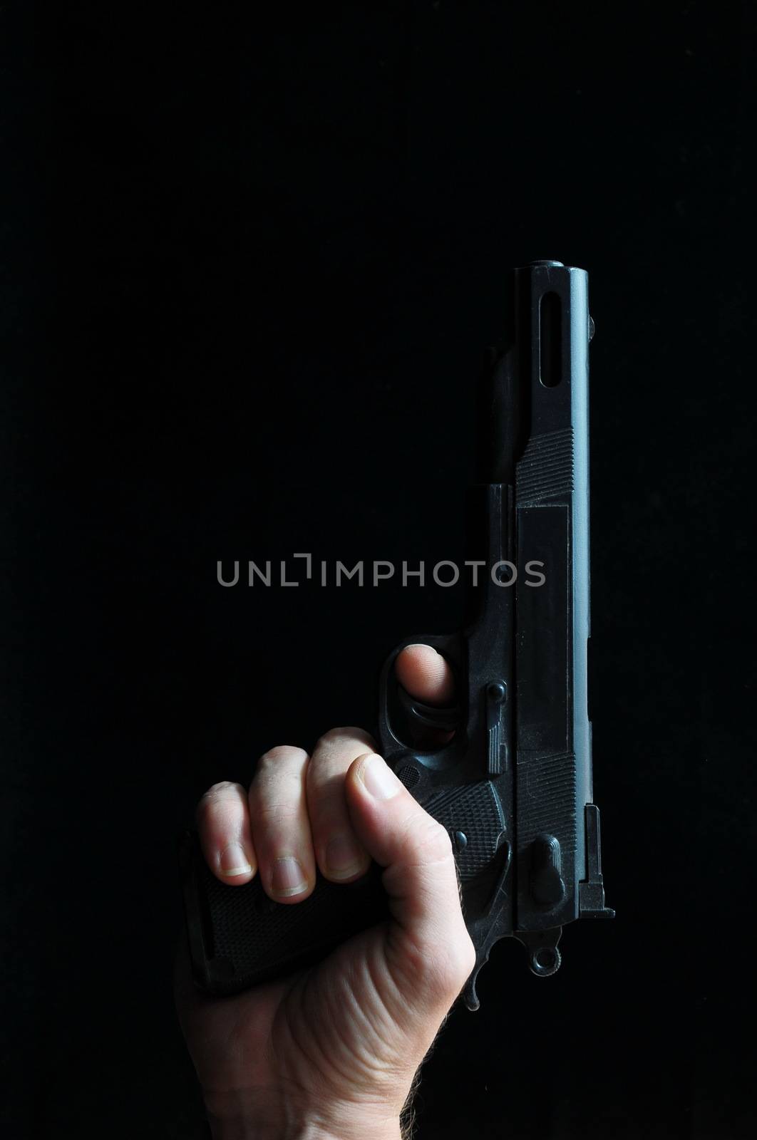 Gun and a Hand on a Black Background