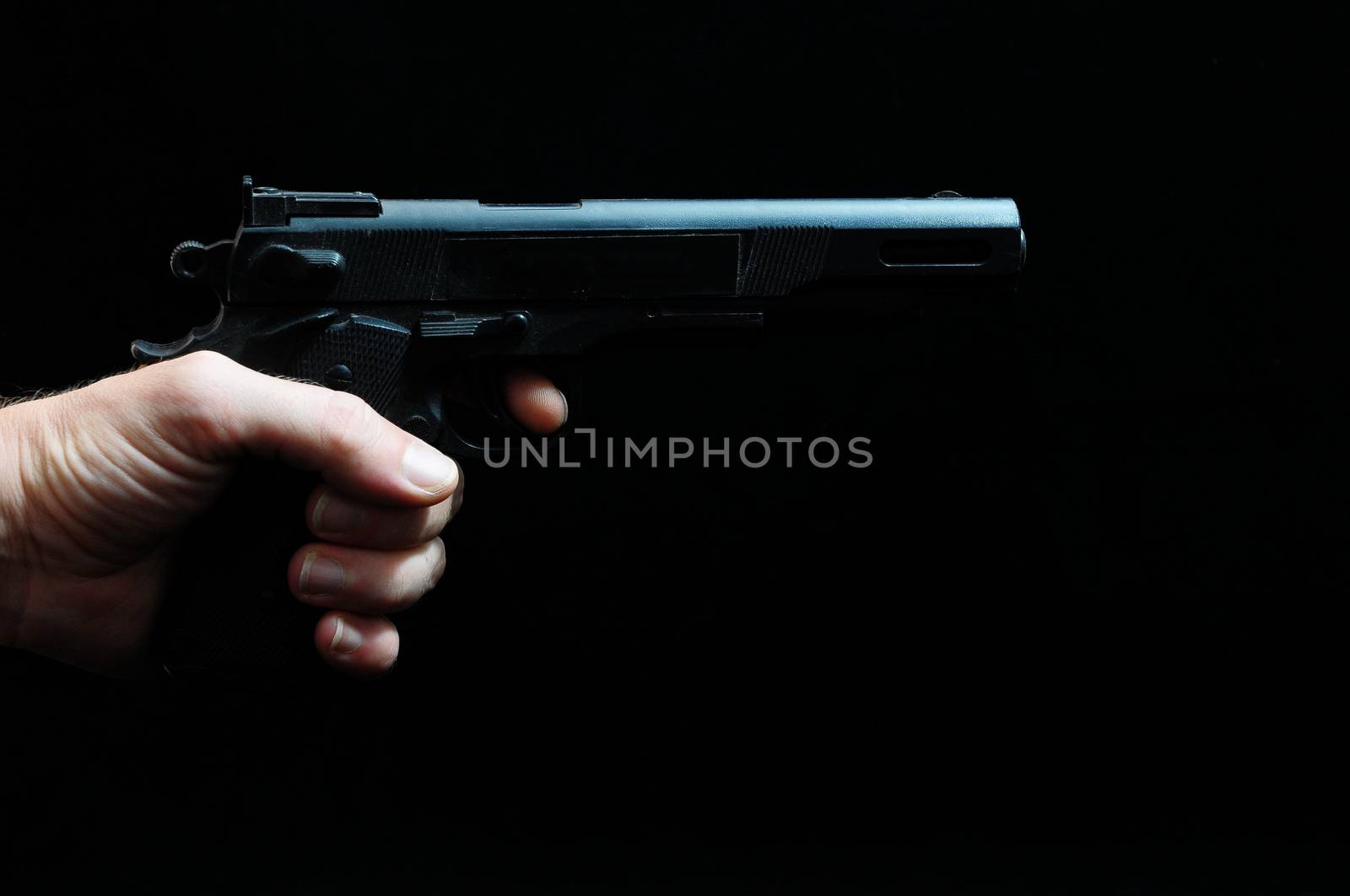 Gun and a Hand on a Black Background by underworld