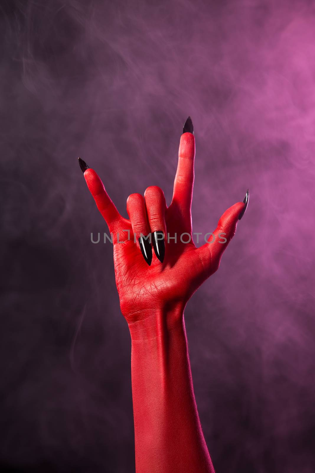 Rock sign, red devil hand with black nails, Halloween 