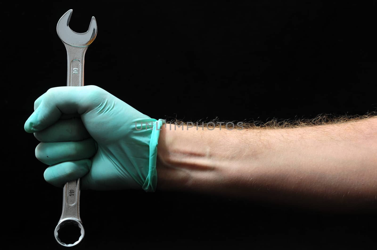 One Key Bolts and a Hand on a Black Background