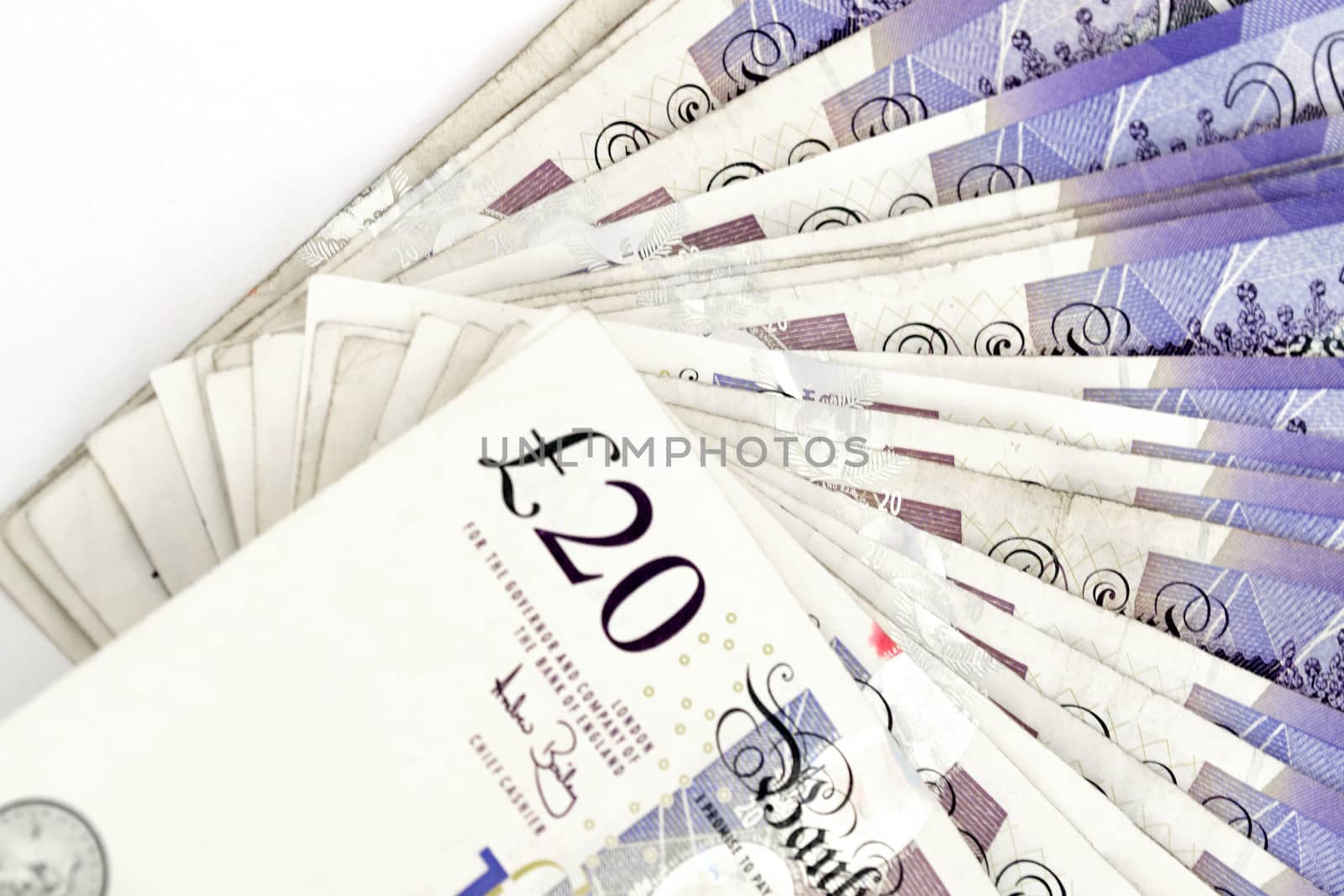 Twenty pounds sterling notes on a white background