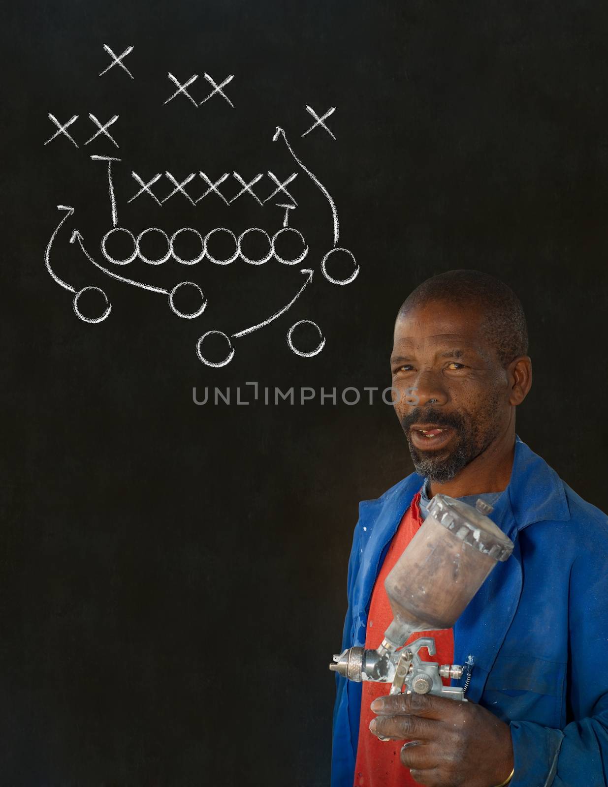 African American black man industrial worker with chalk game plan on a blackboard background