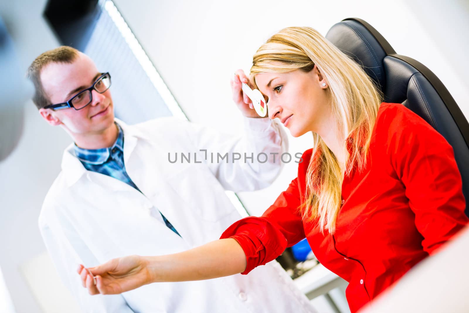 Optometry concept - pretty young woman having her eyes examined by an eye doctor (color toned image; shallow DOF)