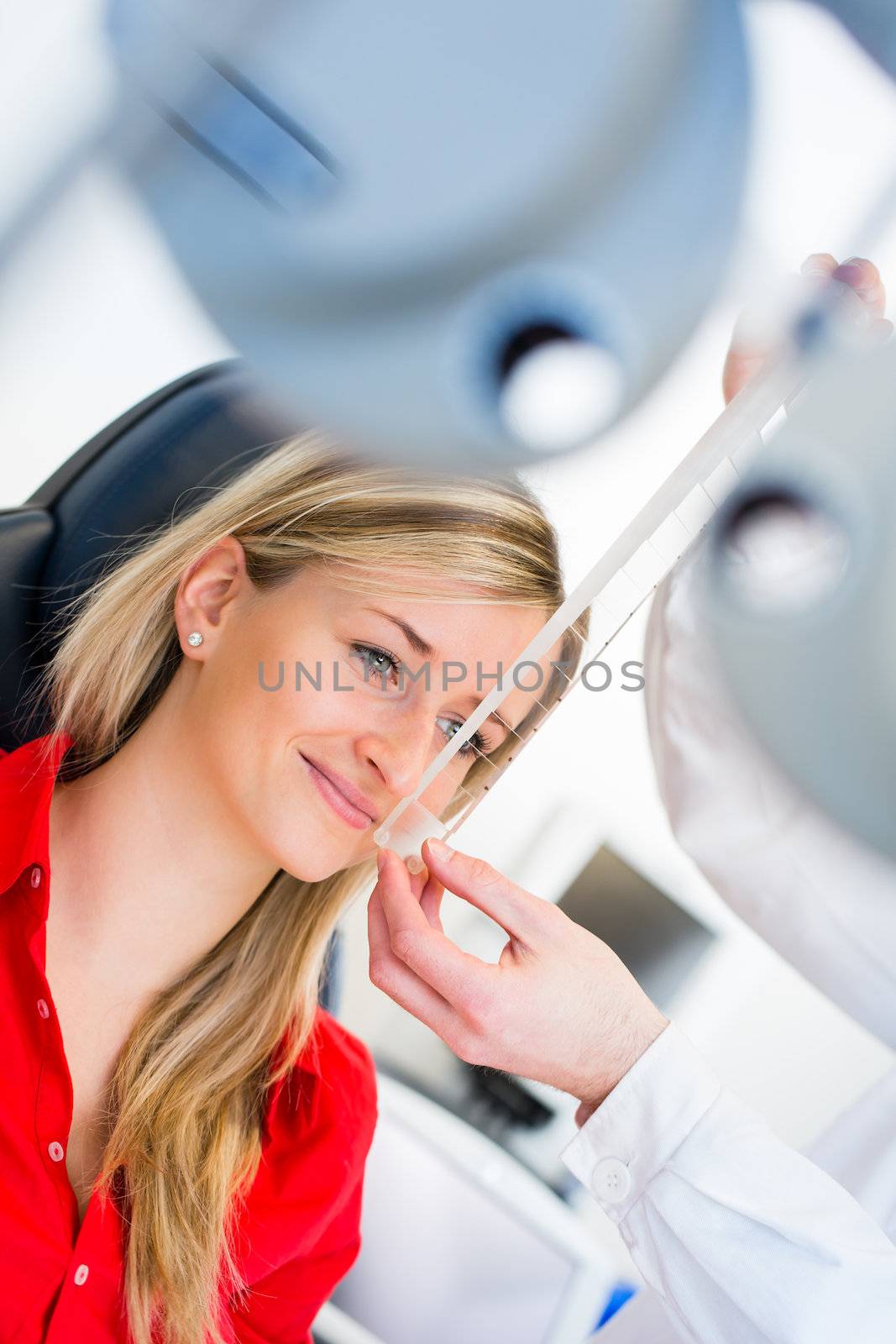 Optometry concept - pretty young woman having her eyes examined  by viktor_cap