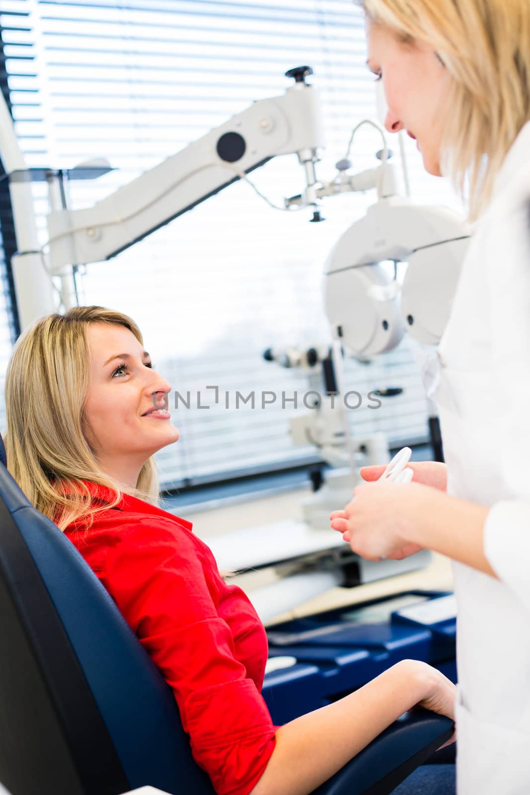 Optometry concept - pretty young woman having her eyes examined  by viktor_cap