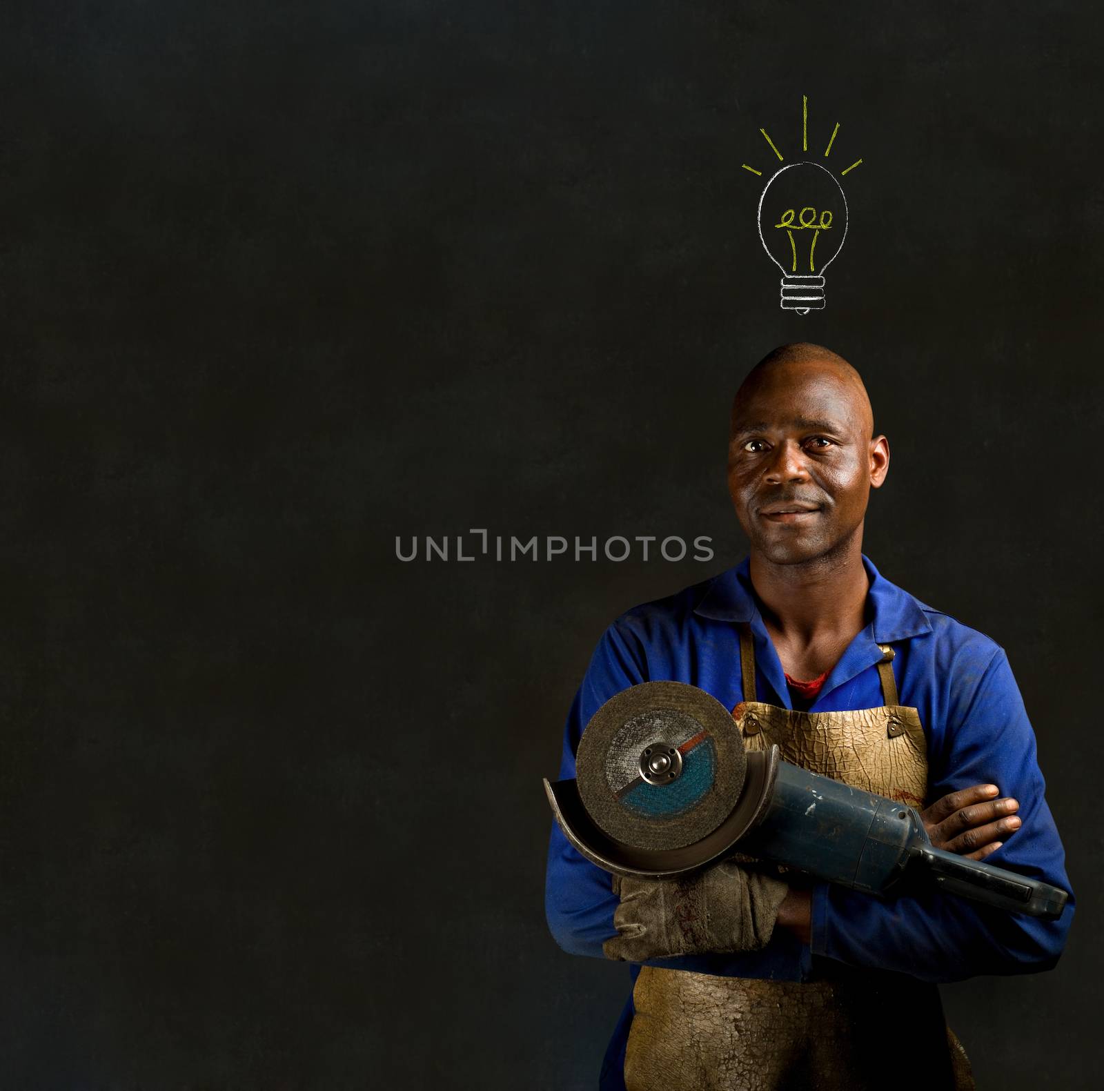 African American black man industrial worker with chalk light bulb on a blackboard background