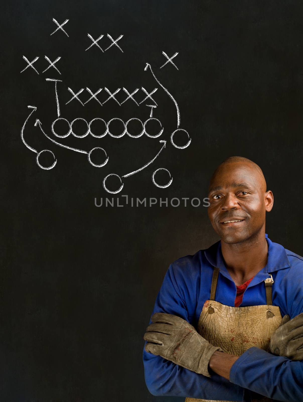 African American black man industrial worker with chalk game plan on a blackboard background