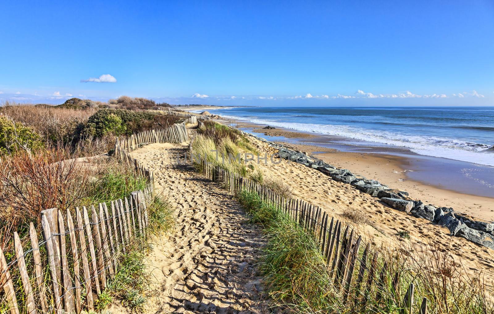 Footpath between wooden fences on the Atlantic Dune in Brittany, in north-west of France.