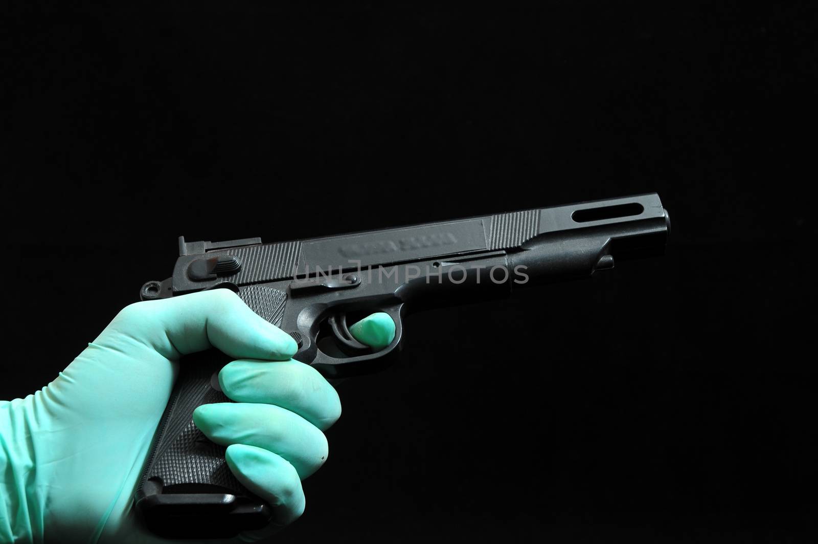 Gun and a Hand on a Black Background by underworld