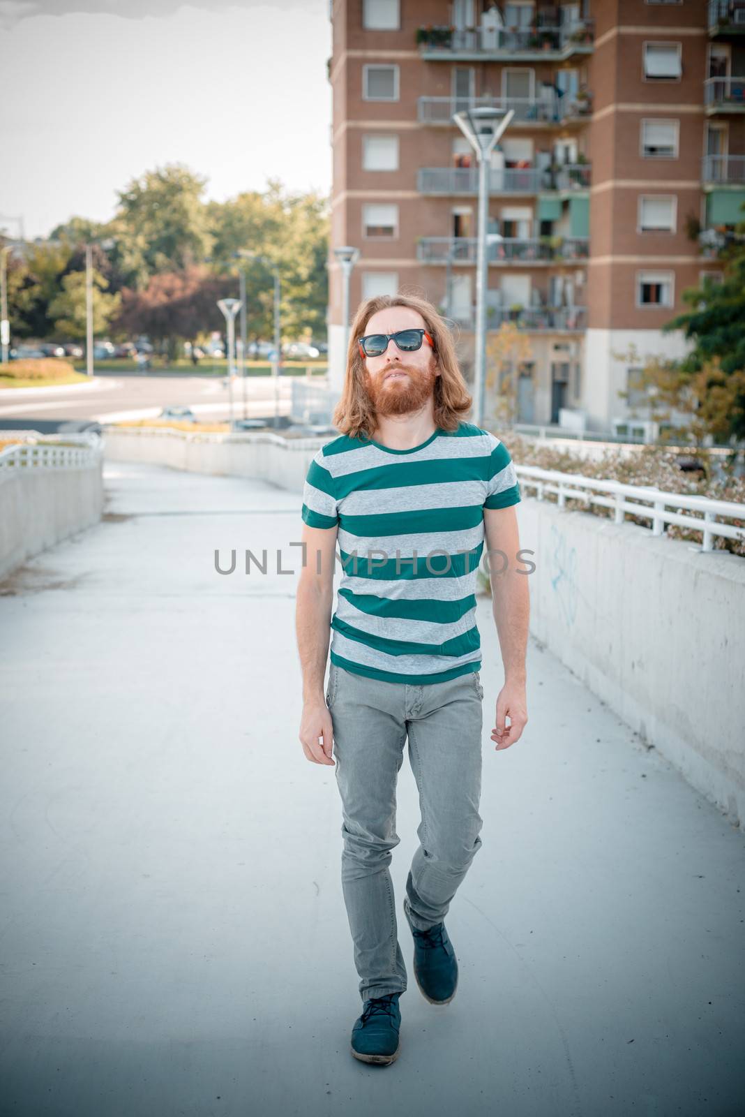 stylish hipster model with long red hair and beard lifestyle by peus