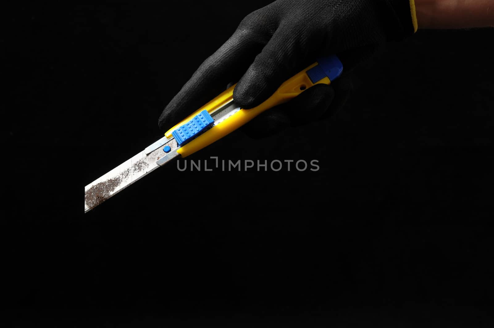 Cutter and a Hand on a Black Background