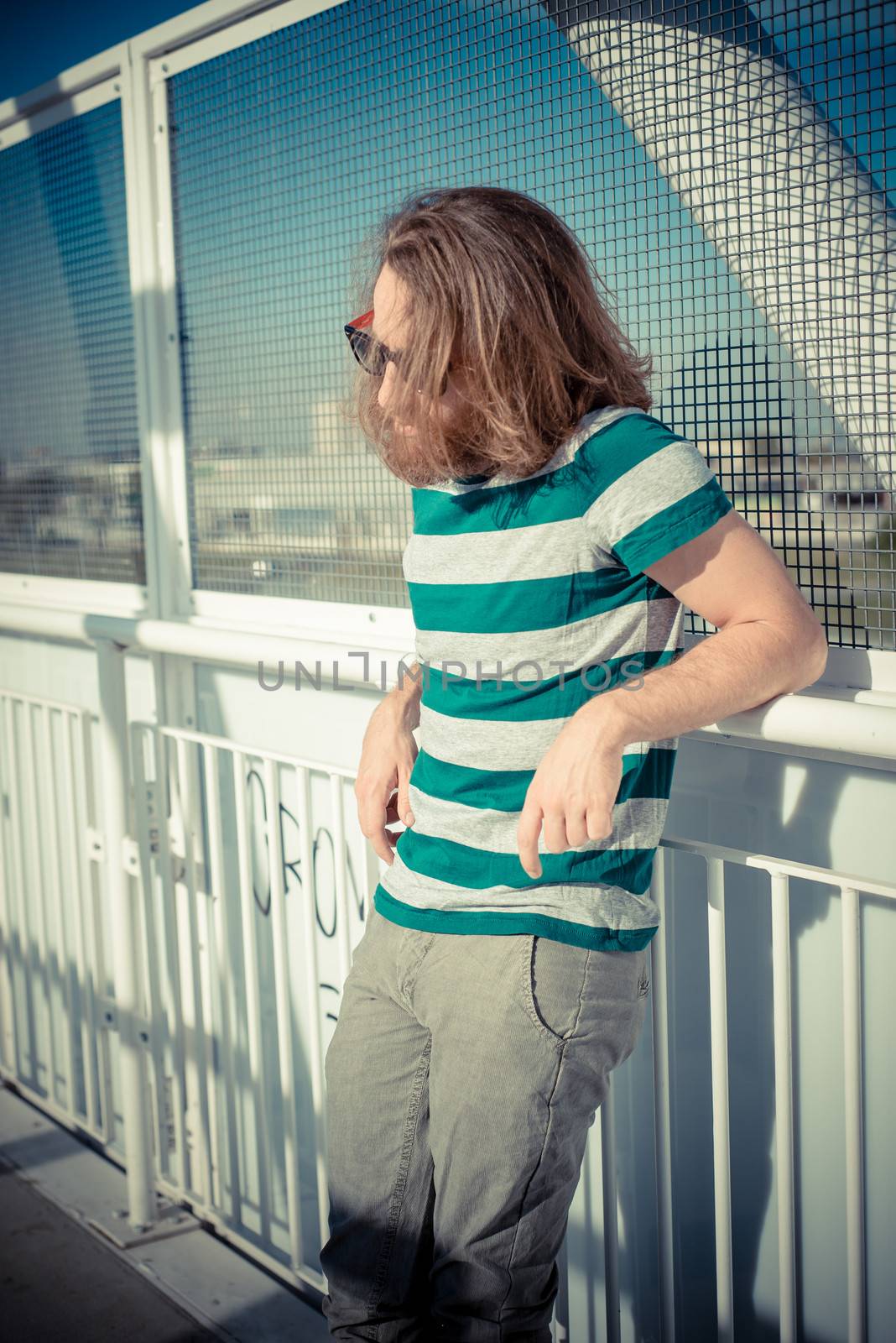 stylish hipster model with long red hair and beard lifestyle in the street