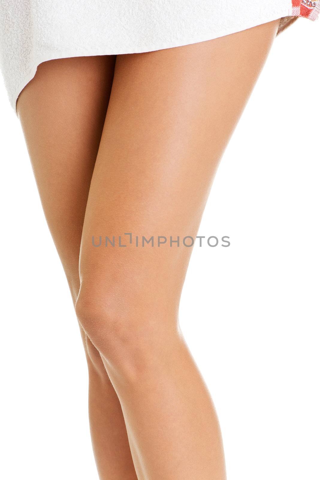 Beautiful female legs covered with a white towel , isolated on white