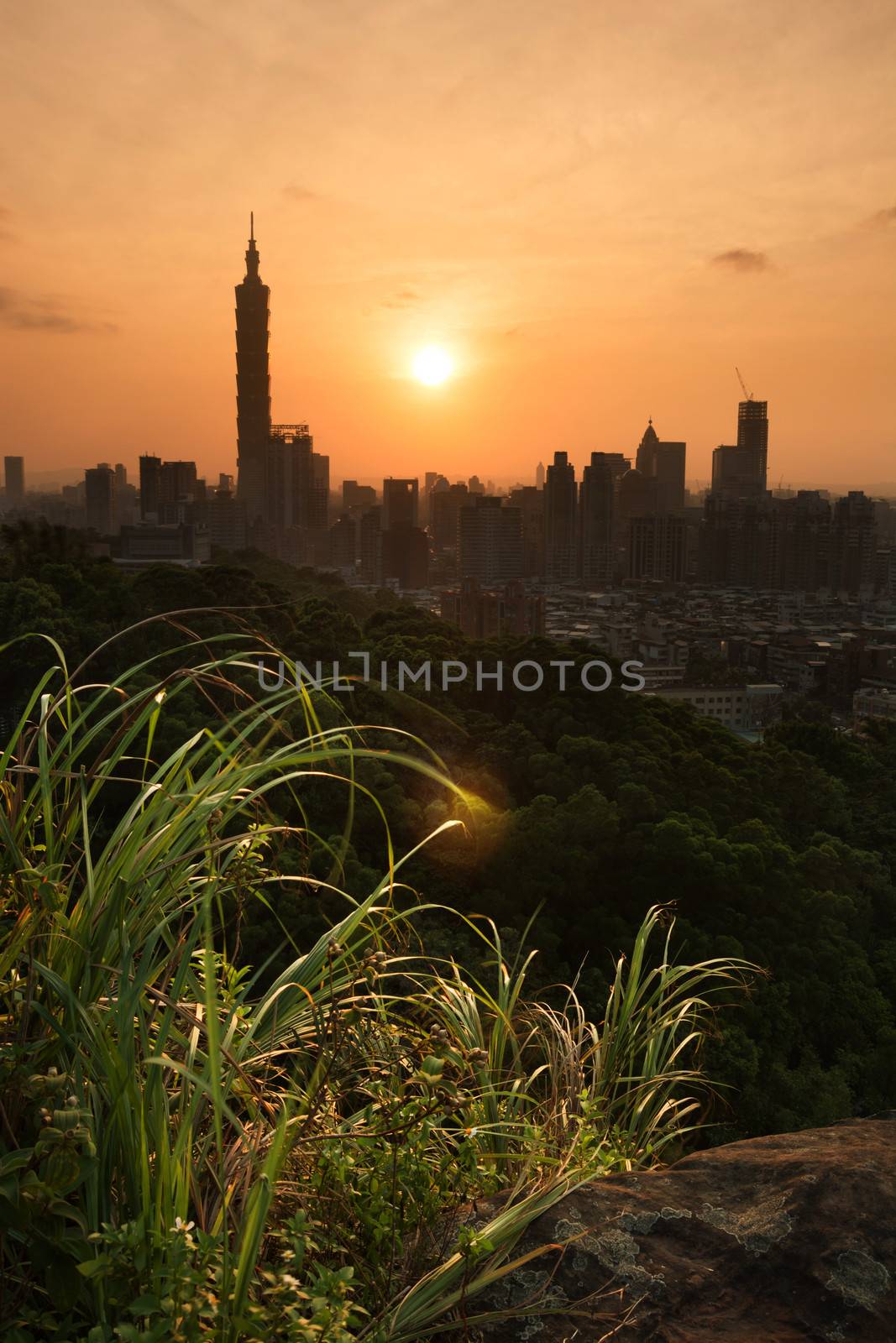 Sunset cityscape with dramatic clouds in orange and yellow color in Taipei, Taiwan, Asia.
