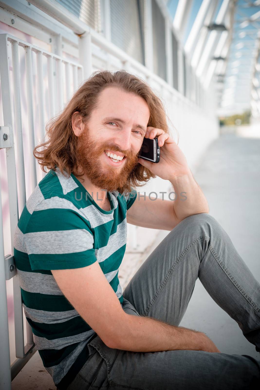 stylish hipster model with long red hair and beard lifestyle on  by peus