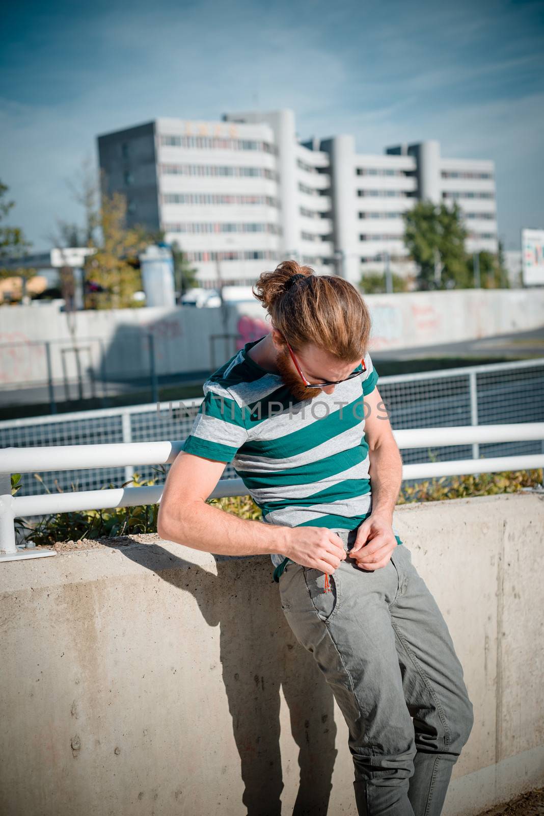 stylish hipster model with long red hair and beard lifestyle in the street