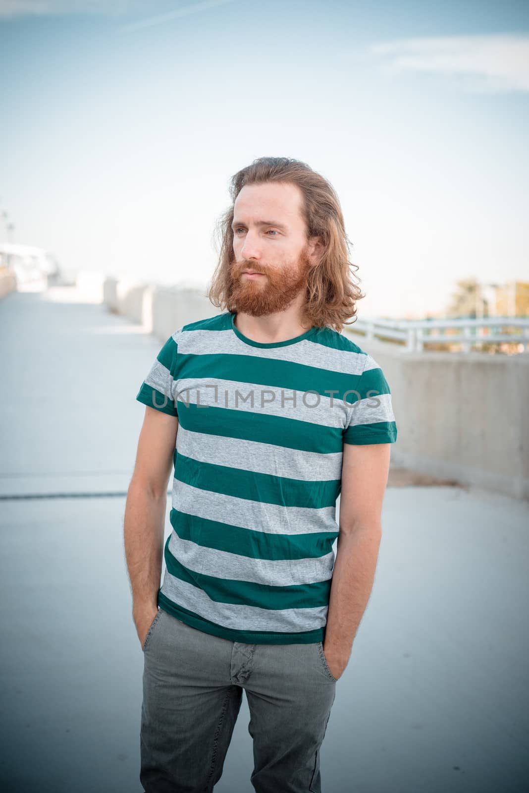 stylish hipster model with long red hair and beard lifestyle by peus