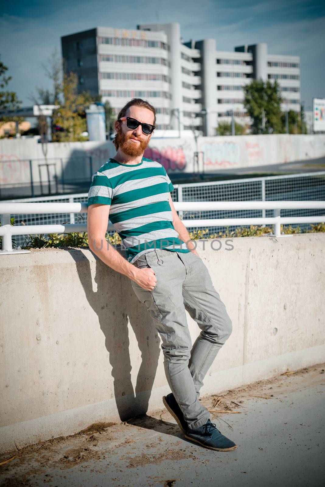 stylish hipster model with long red hair and beard lifestyle in the street