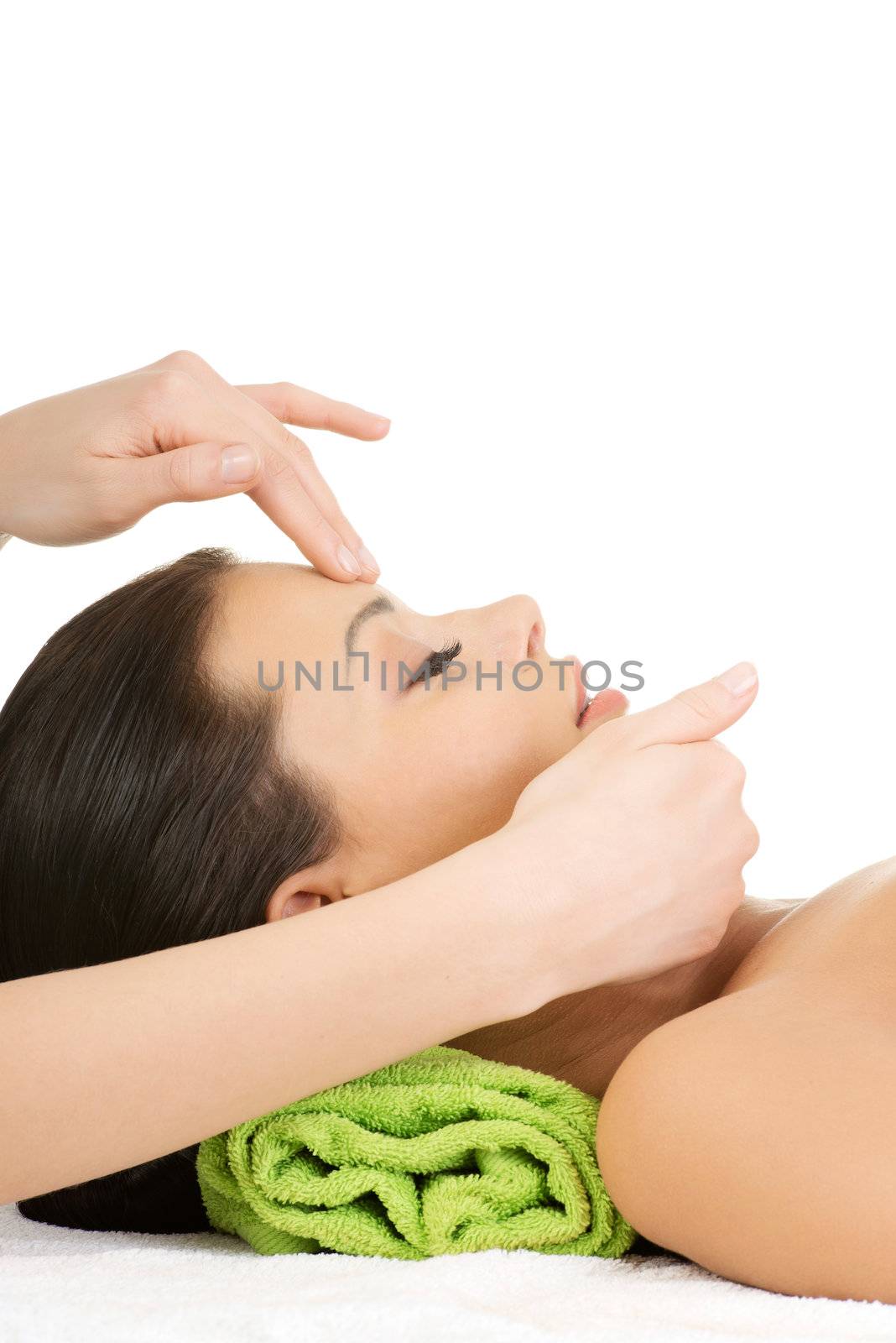 Beautiful relaxed woman enjoy receiving face massage by BDS