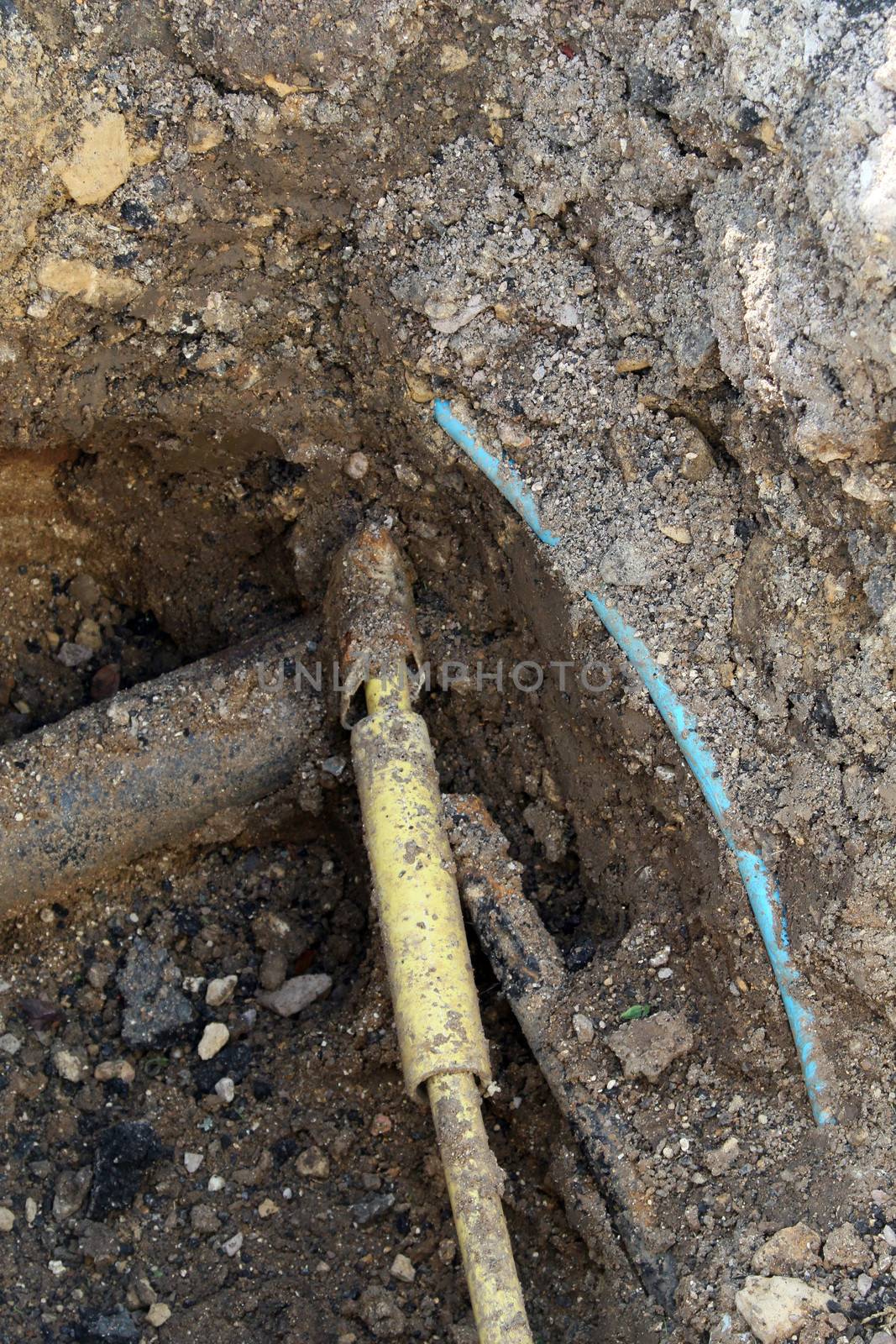 Underground pipe work undergoing repair in a street in England.